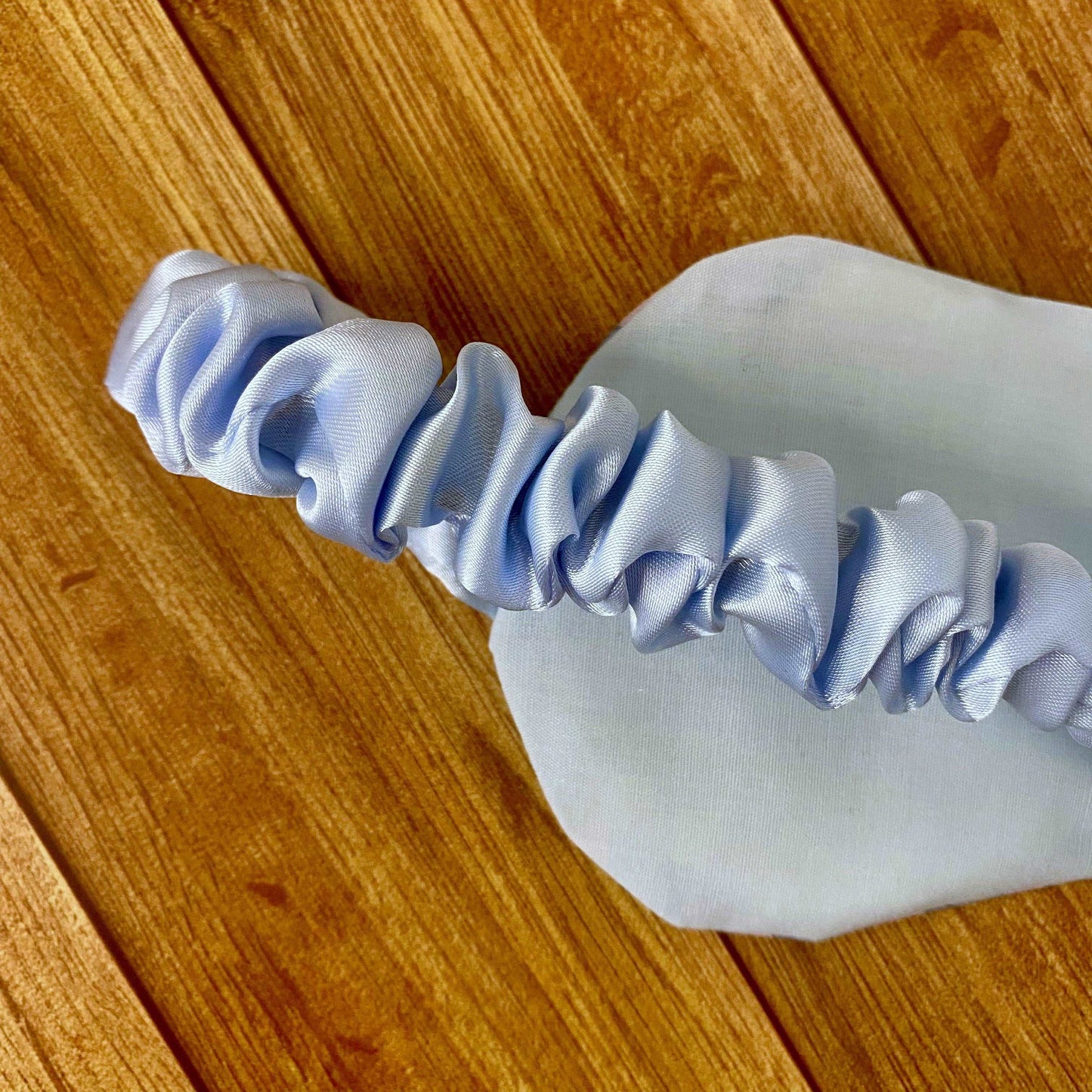 closeup of the back of the sleepmask, showing blue interior of the mask and blue satin strap