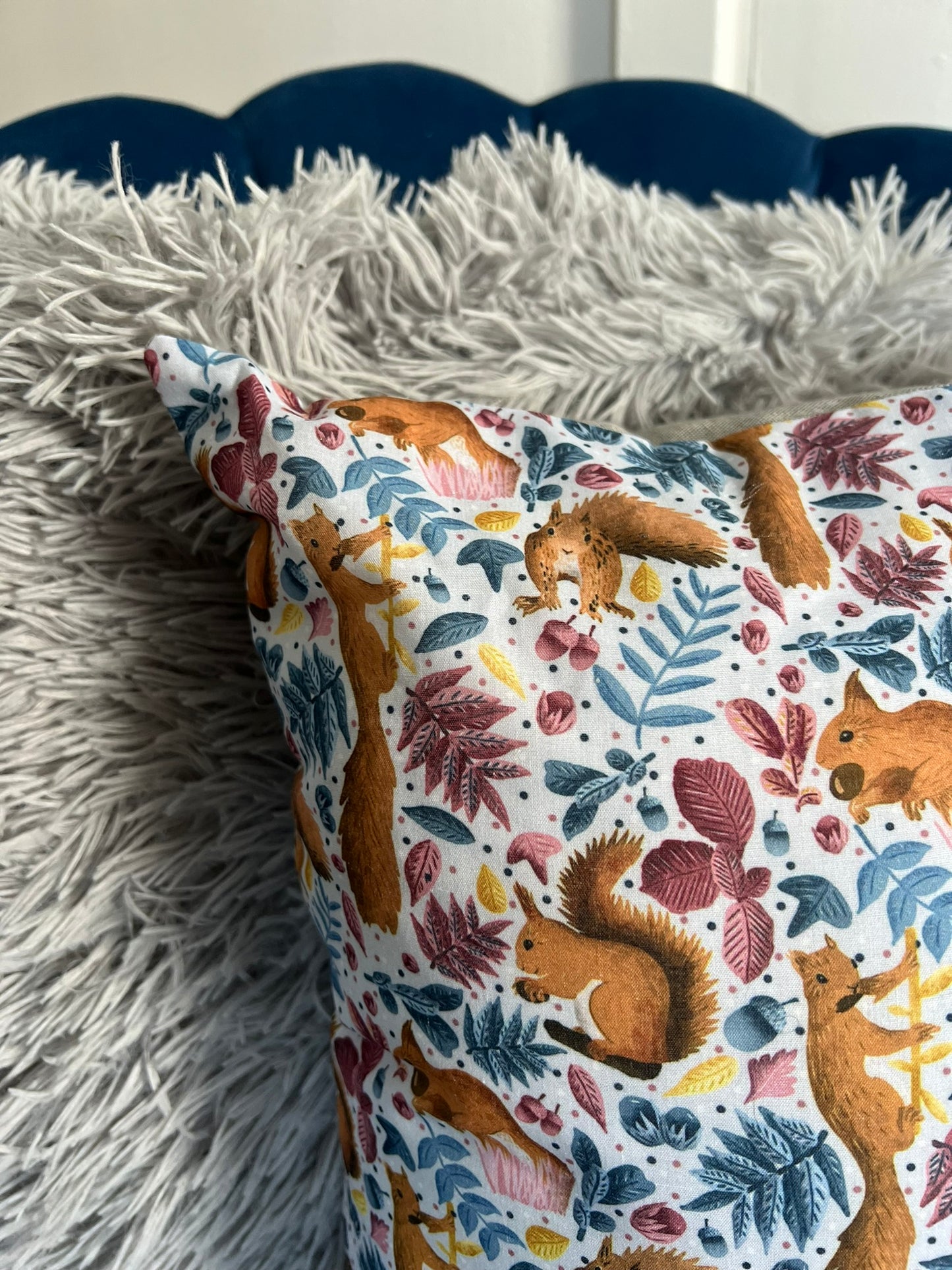 closeup of red squirrel decorative cushion for sofa, with a fun squirrel pattern on the front. Ideal as a squirrel gift idea for someone who loves animals.