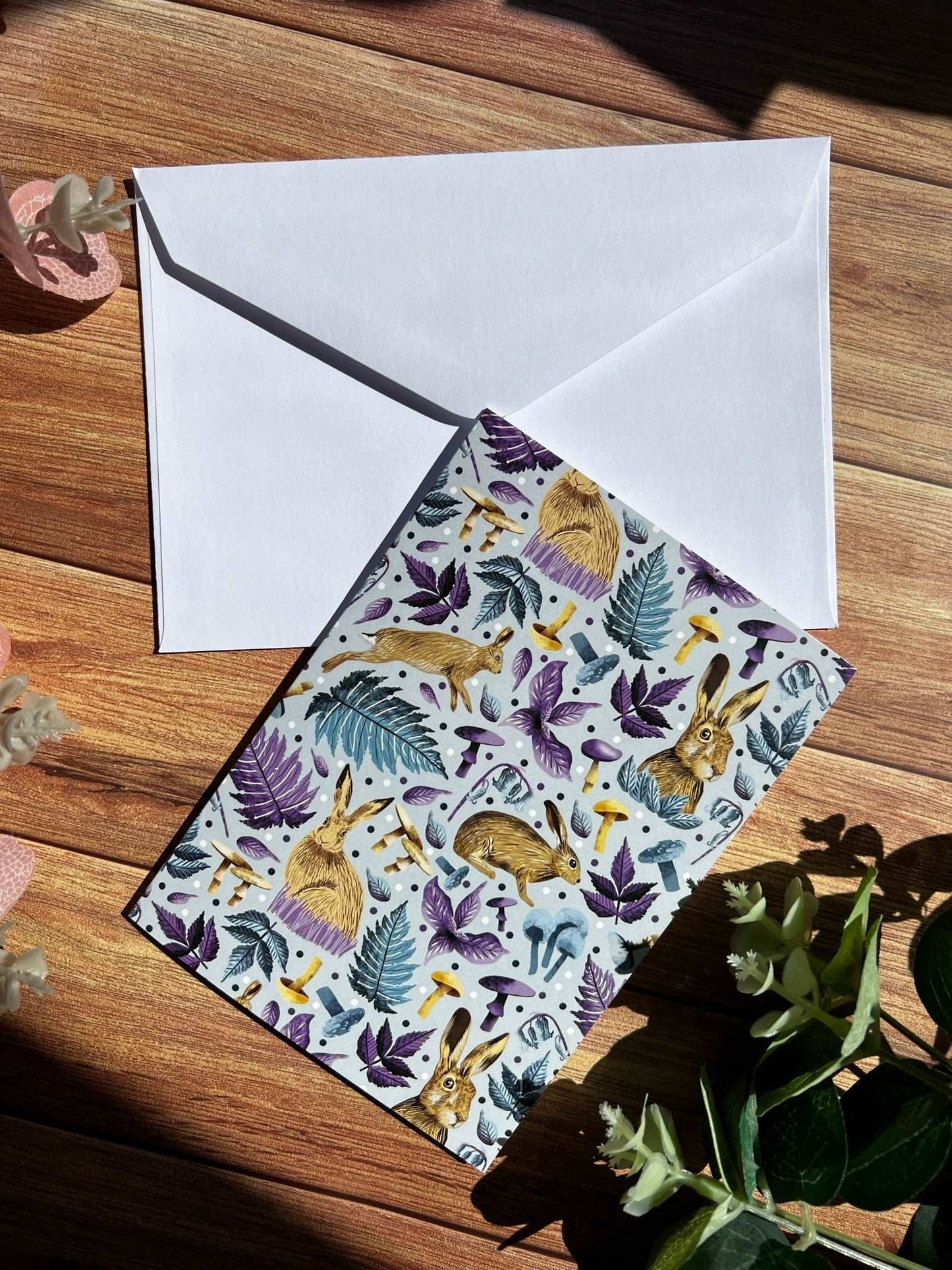 This hare greeting card shows the greeting card art on the fron with a white envelope behind it