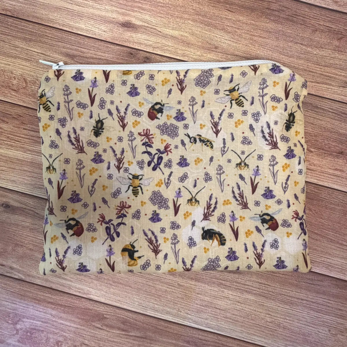 Compact fabric bee makeup pouch suitable for cosmetics, skincare essentials and everyday accessories.