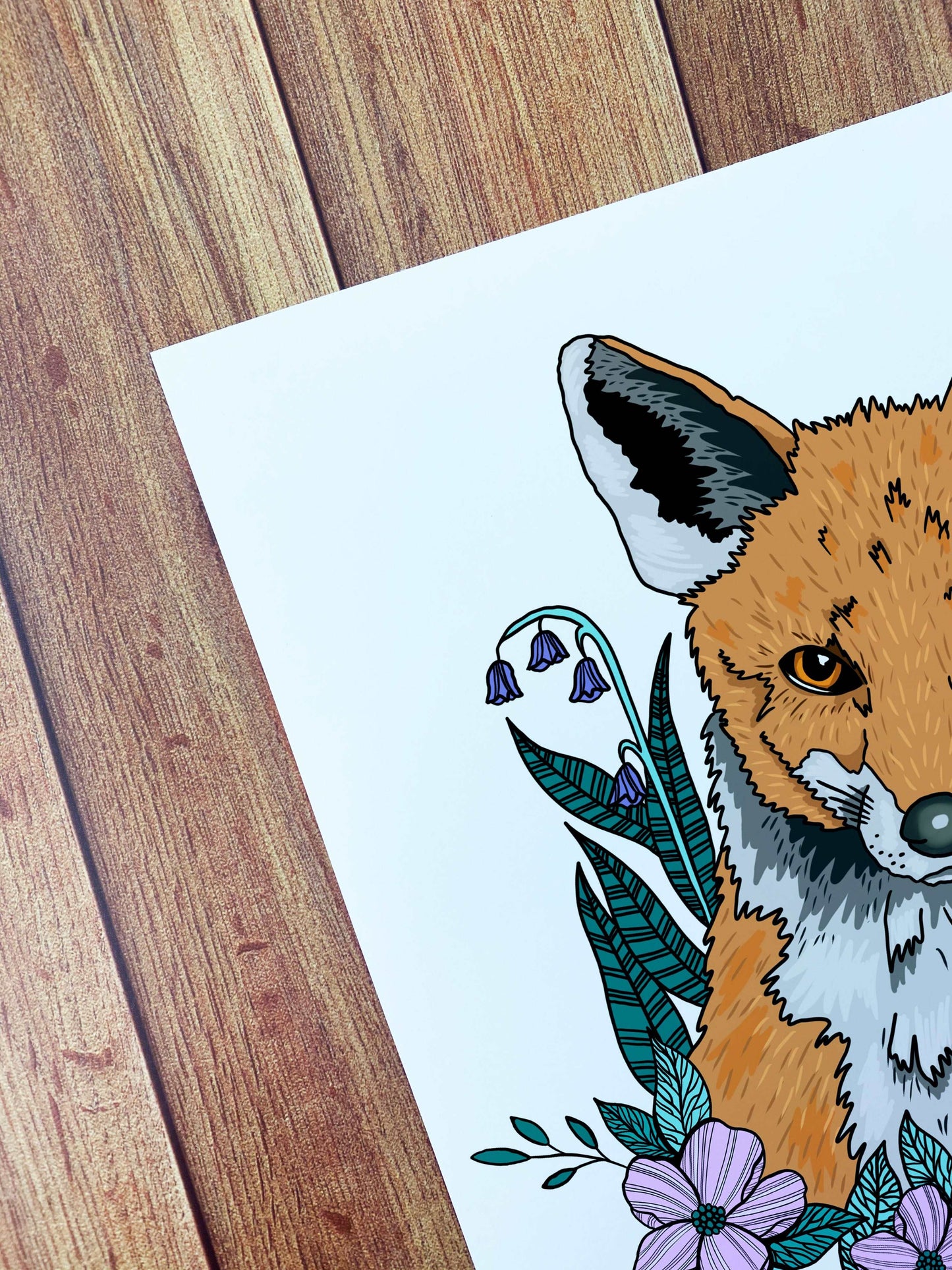 An image of a fox a4 art print for wall decor, an ideal gift for an animal lover. It shows the modern illustration style of a fox and flowers around it.