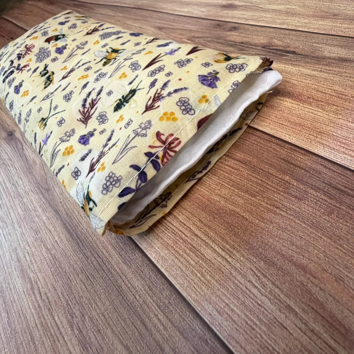 Bee patterned microwave wheat bag designed for reusable warmth at home.