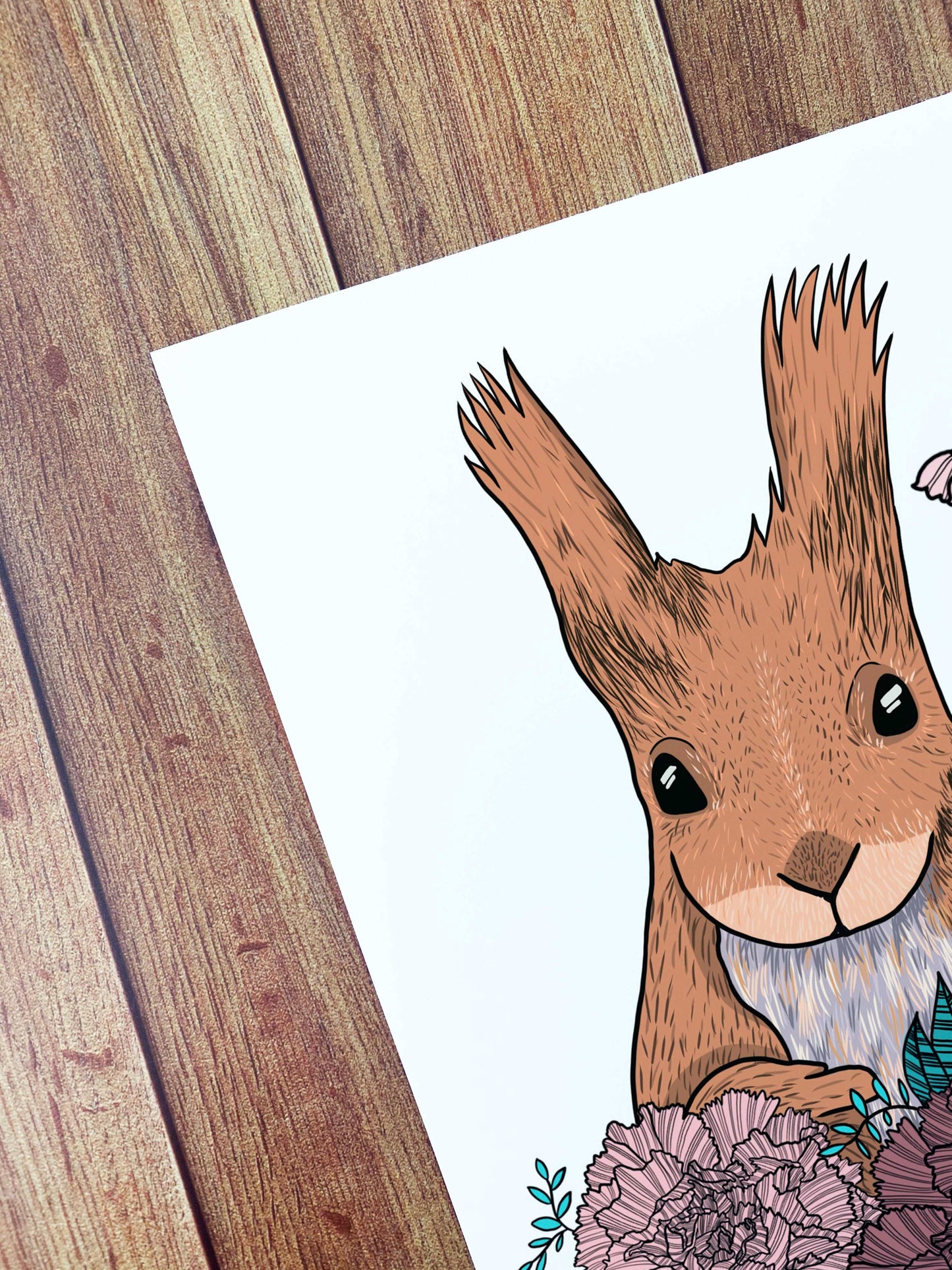 corner of the red squirrel art print showing a close up of the corner and the details of the red squirrel illustration and some of the flowers. Ideal for display on a living room wall, the red squirrel art print is a great gift for an animal lover.