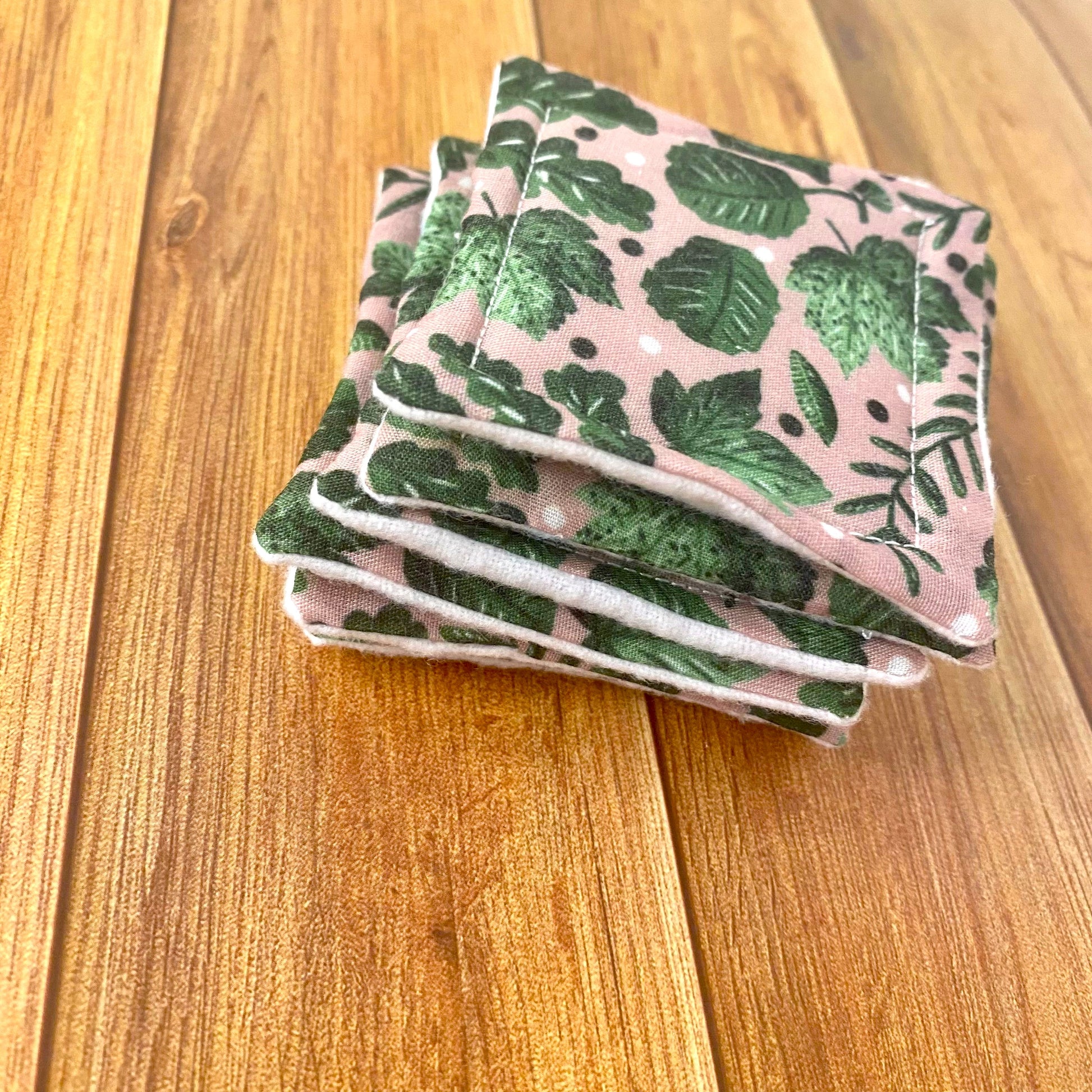A stack of reusable skincare pads on a wooden background
