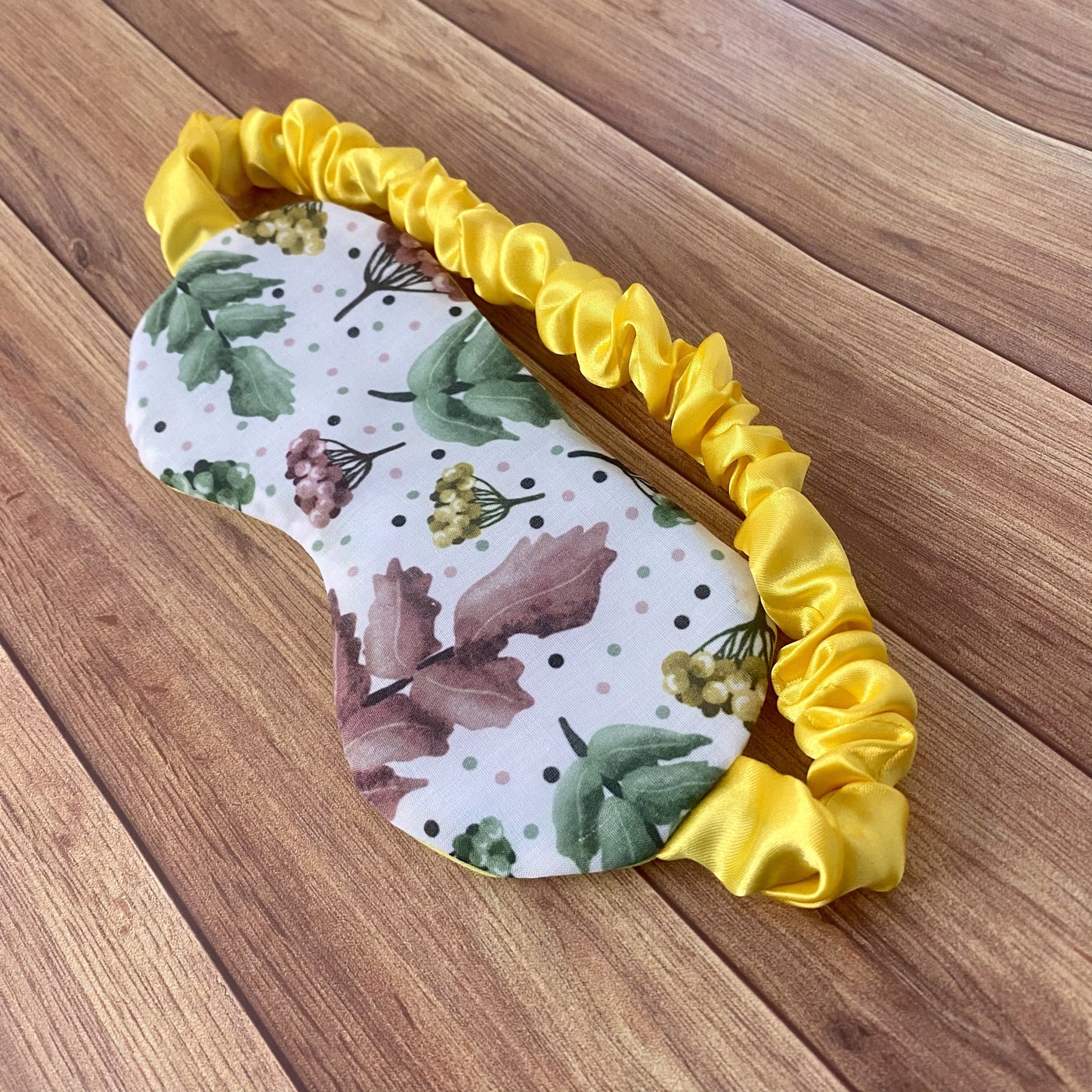 pretty foliage patterned sleepmask on wood surface