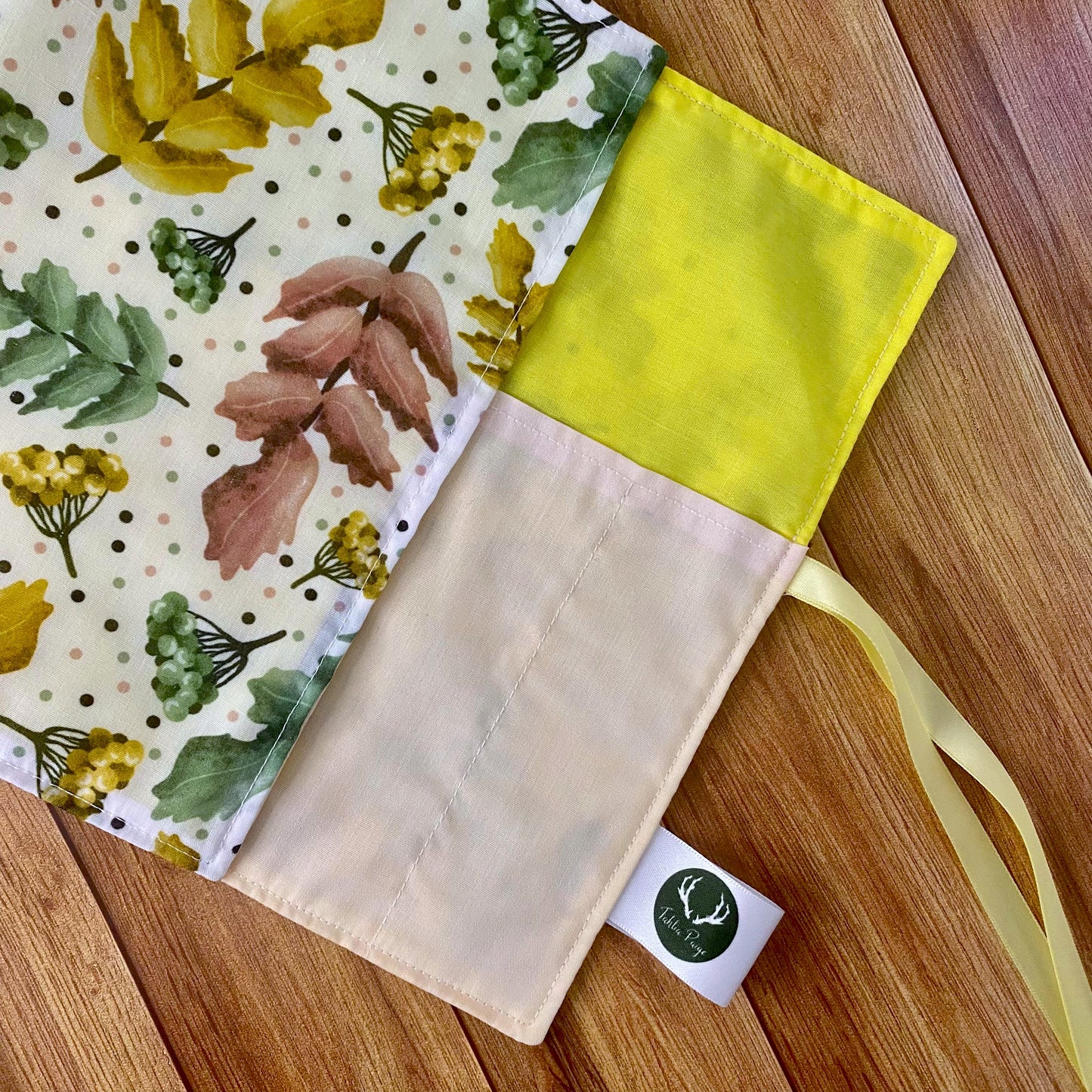 Inside pockets of a roll up storage bag for makeup brushes with a patterned design