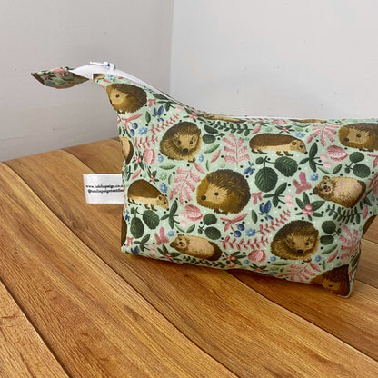 photograph of a full hedgehog patterned makeup bag showing the size and shape from the side.