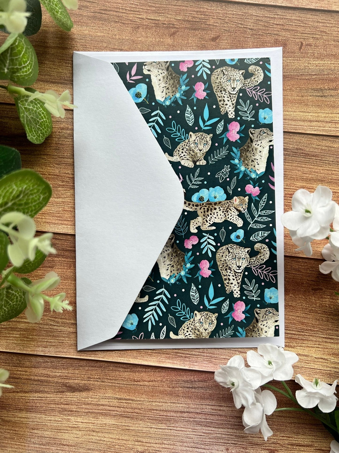 a snow leopard greeting card with a white envelope