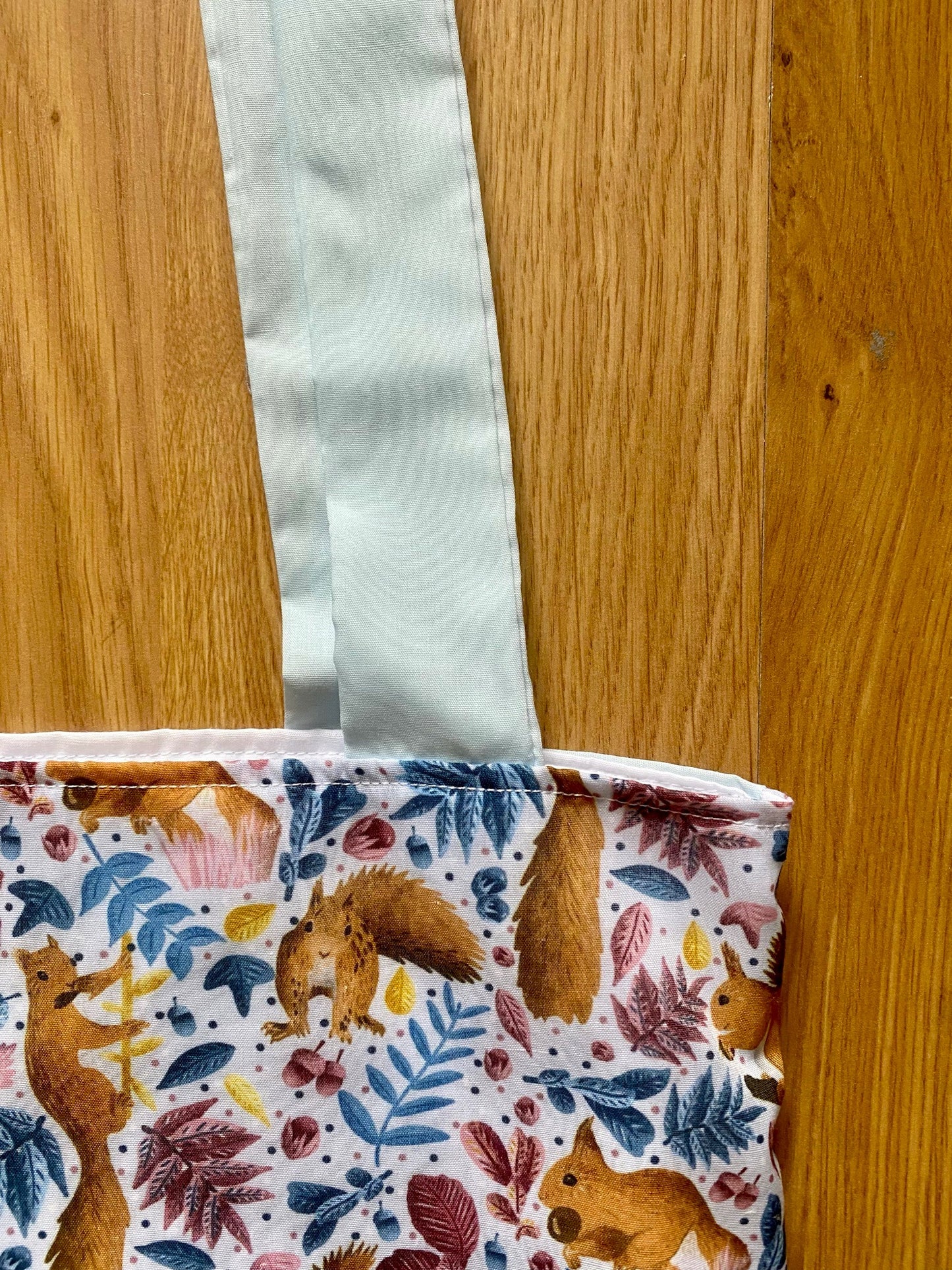 Adorable red squirrel design on a cotton tote bag, perfect for woodland animal gifts and eco-friendly shopping."