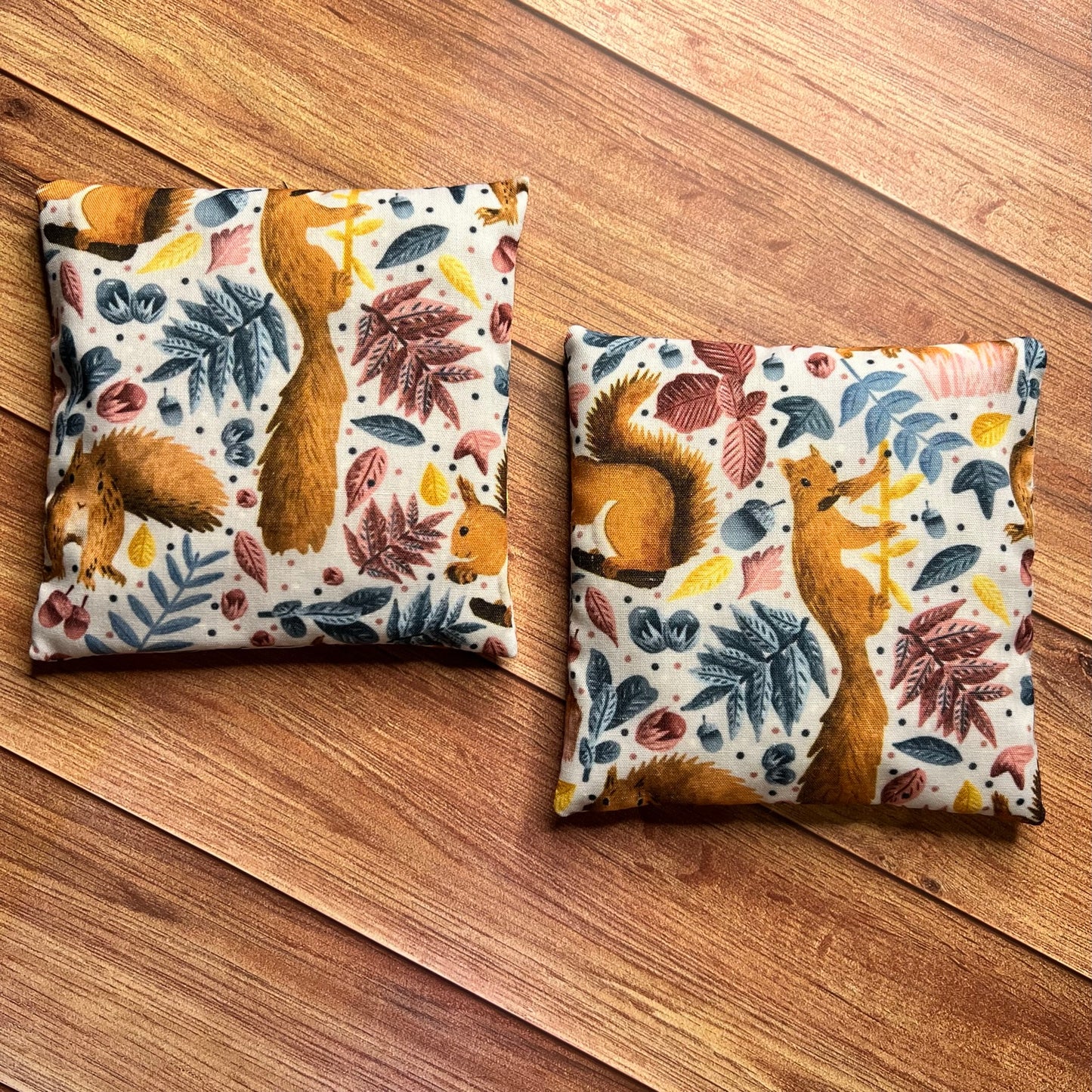 enjoy red squirrel gifts with these cute hand warmers with the red squirrle pattern, these can help with cold hands.