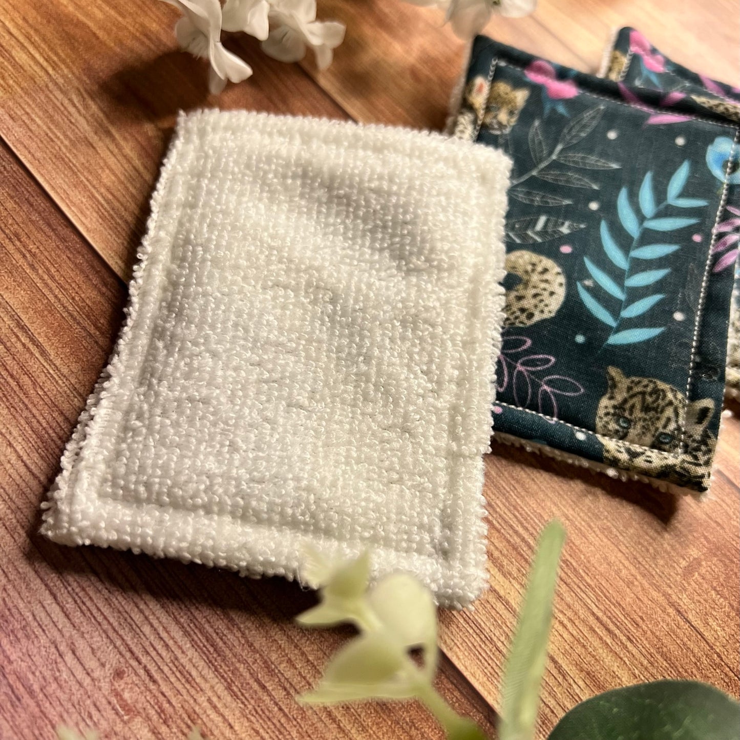 Cotton exfoliating pads with snow leopard print, perfect for skincare.