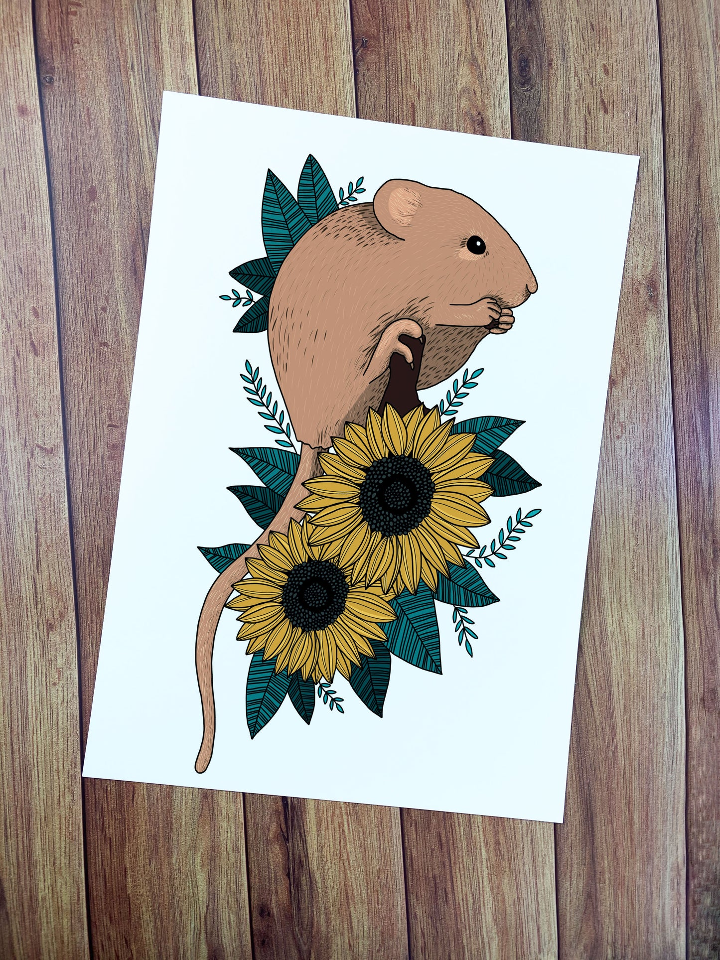 art print of a dormouse and sunflowers illustrated digitally shown flat on wood