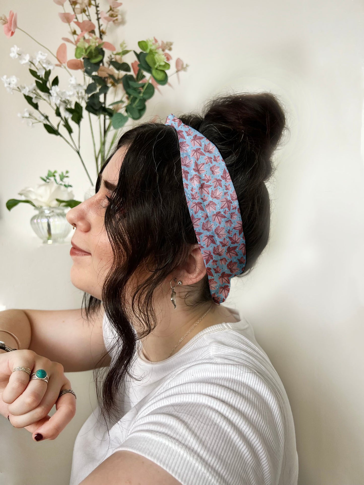 dark haired girl wears pink leafy patterned headband, ideal as a hair accessory for long hair in a lovely leafy pattern