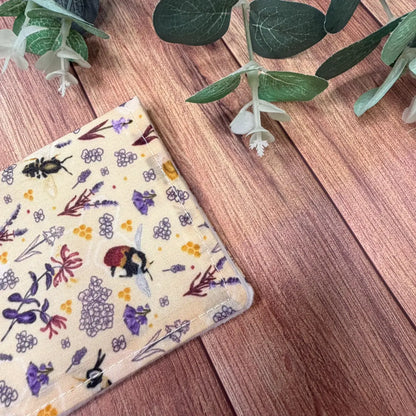 Beekeeping gifts featuring a handmade cotton face washing cloth with illustrated bees.
