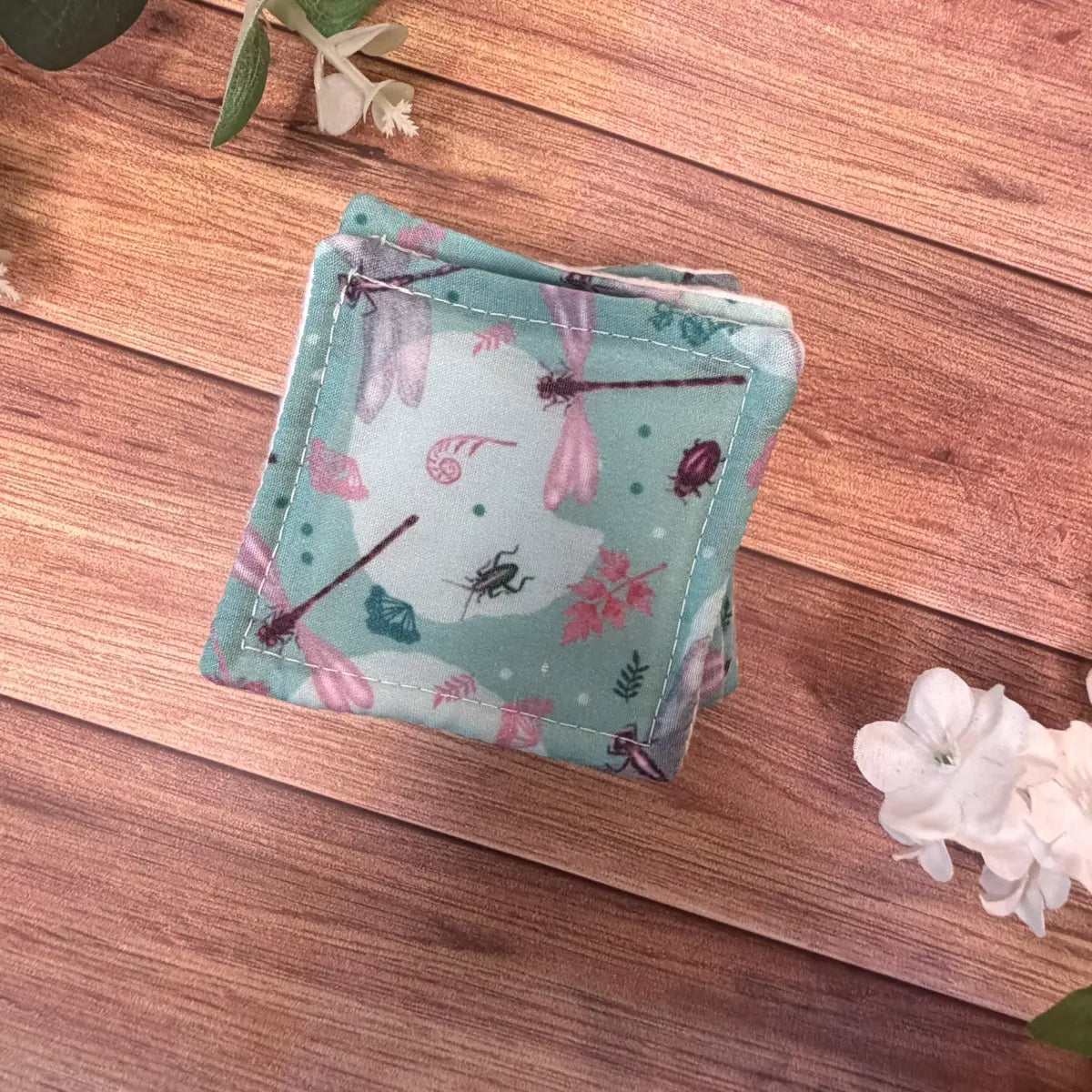 Dragonfly patterned makeup removal pads with soft white brushed cotton surfaces.
