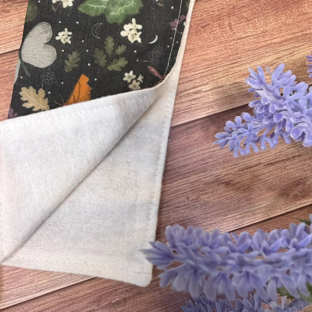 Fabric facial washcloth decorated with original illustrated moth artwork.

