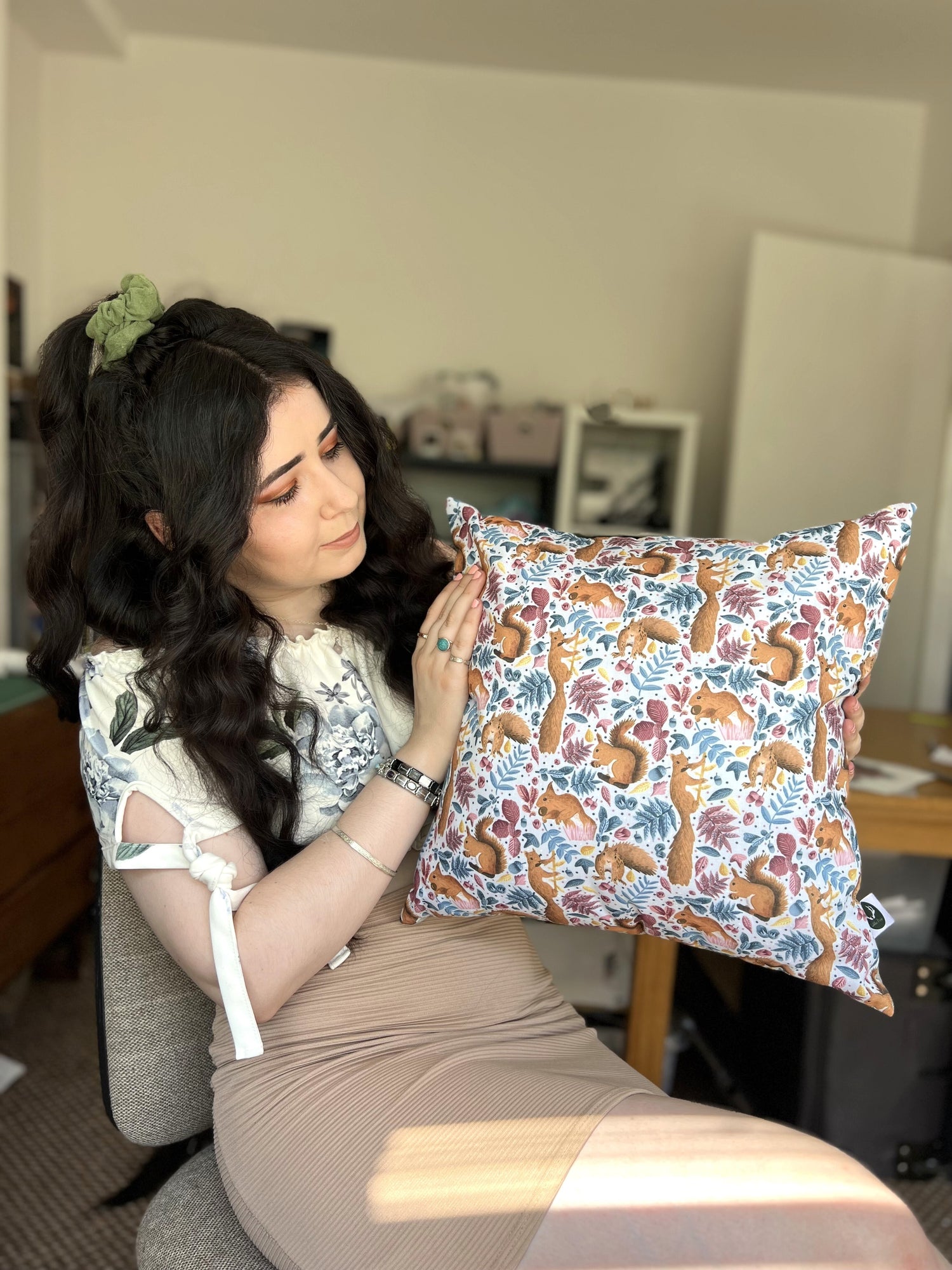 Founder Tahlia Paige holding the red squirrel cushion