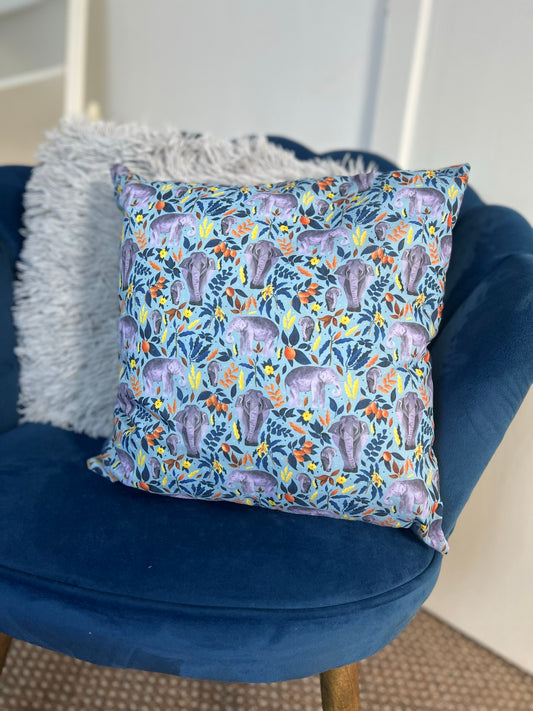 Our decorative cushion is an excellent gift for a elephant lover, seen here on a blue armchair. 