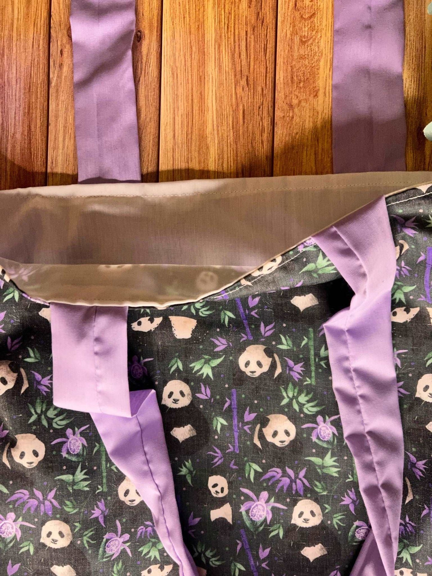perfect for work or as a bookbag, the Panda-patterned tote bag