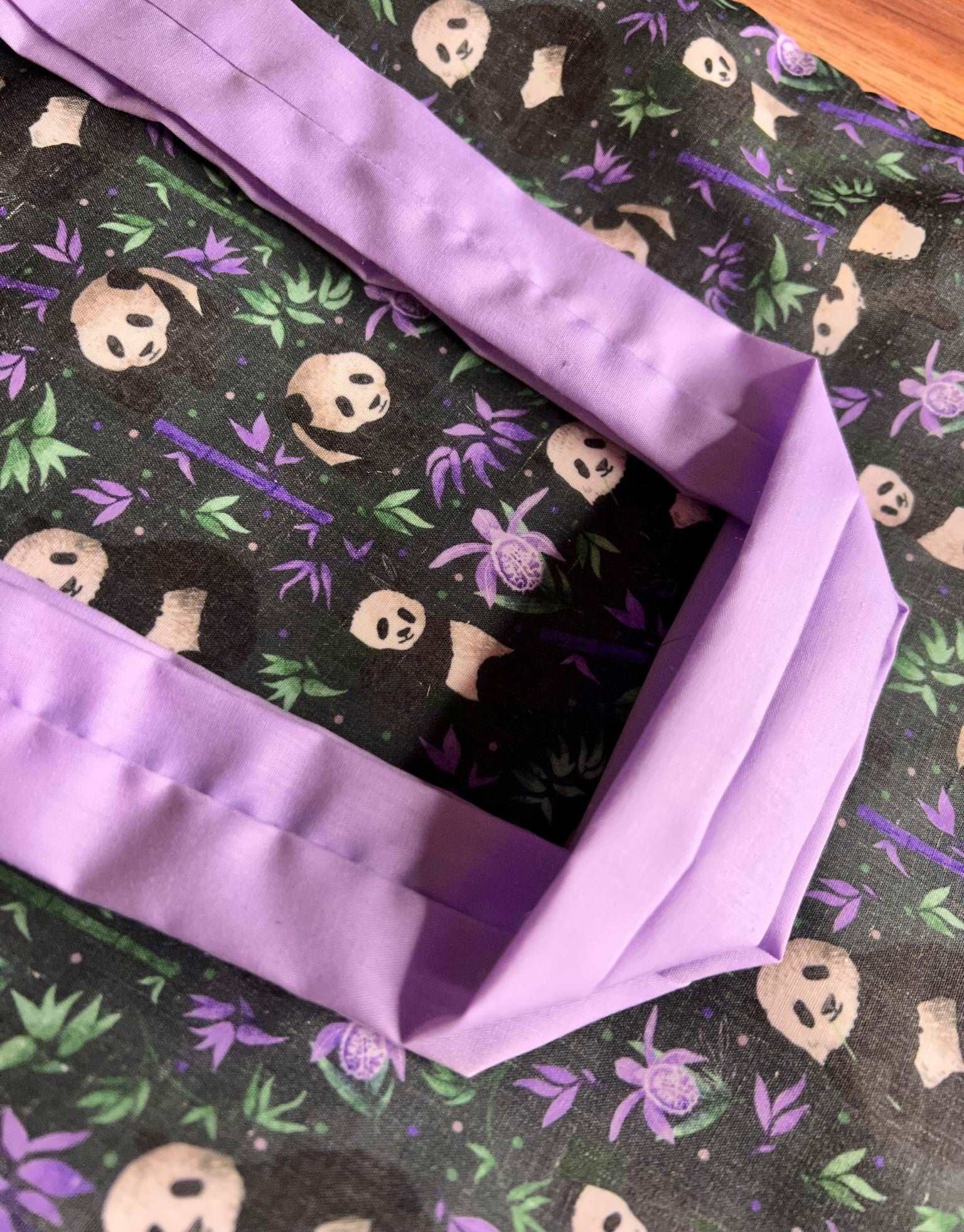 Panda-patterned tote bag, perfect for work or as a bookbag.