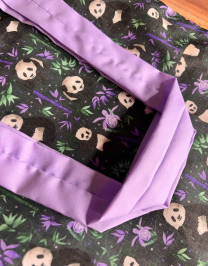 Panda-patterned tote bag, perfect for work or as a bookbag.