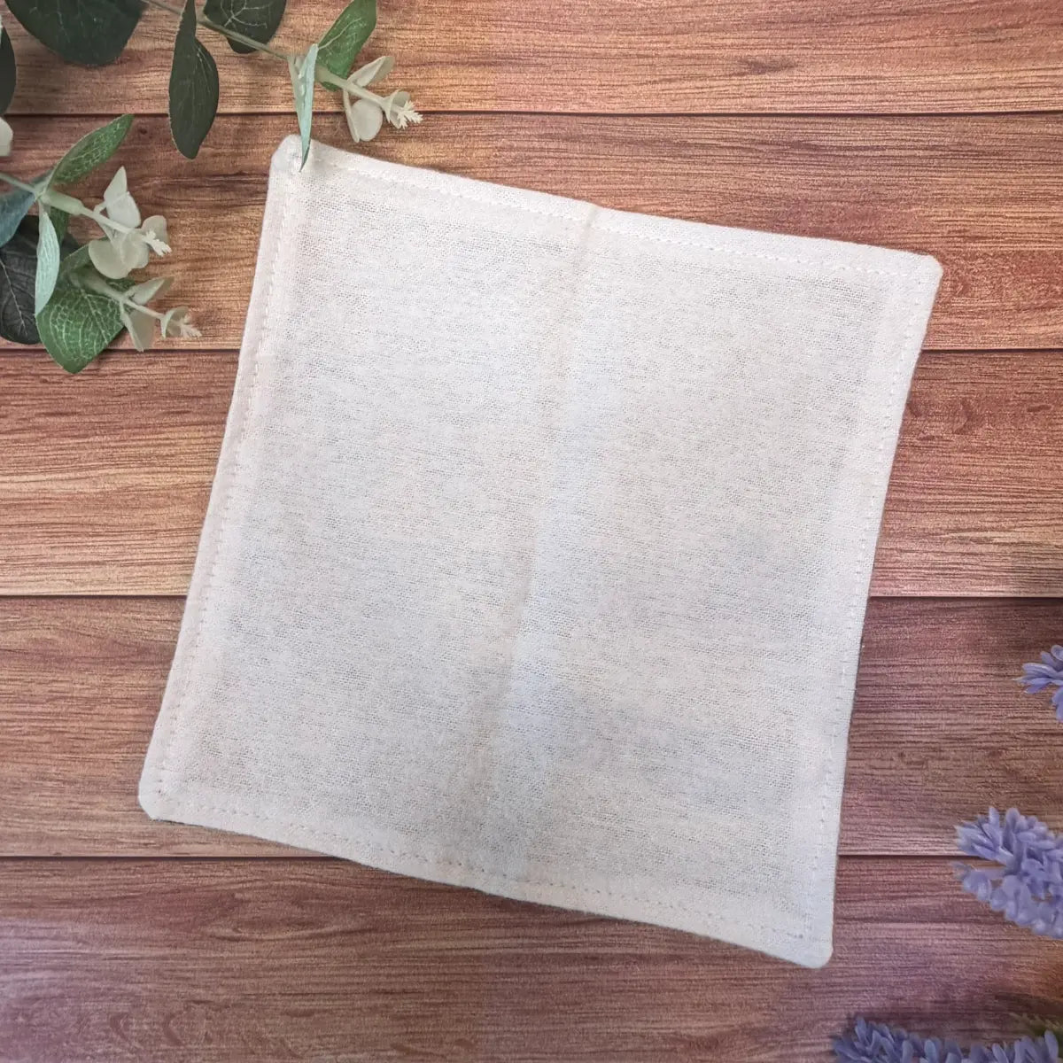 Moth patterned reusable facecloth with a soft white brushed cotton surface.
