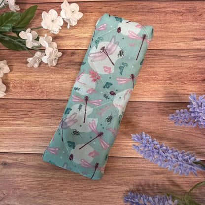 Padded reading glasses case decorated with detailed dragonfly artwork.
