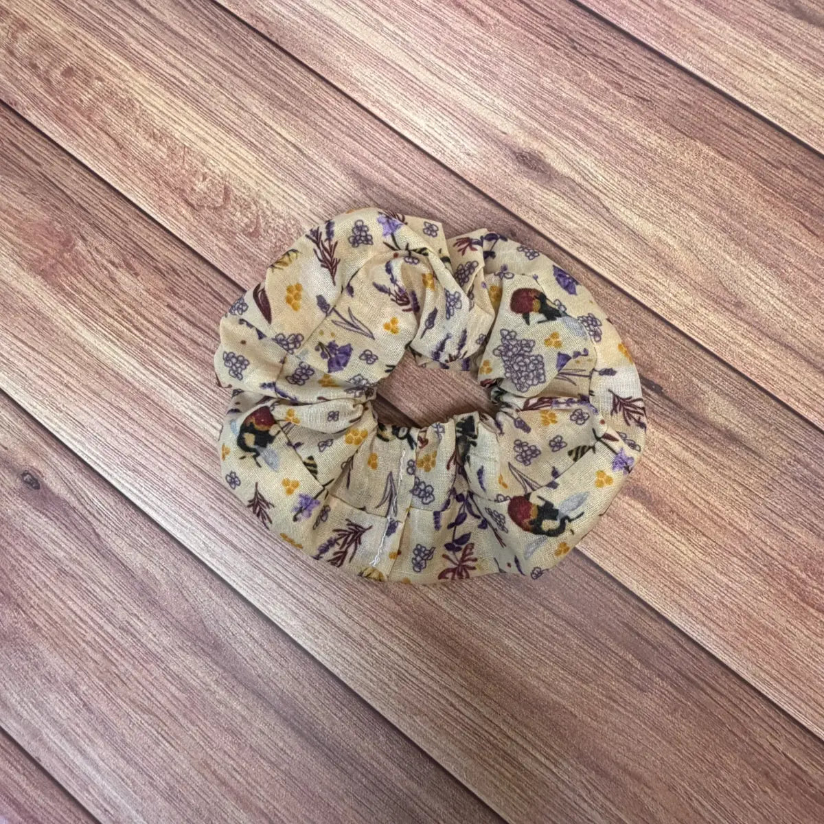 Handmade bee accessories including a cotton scrunchie with gathered fabric.
