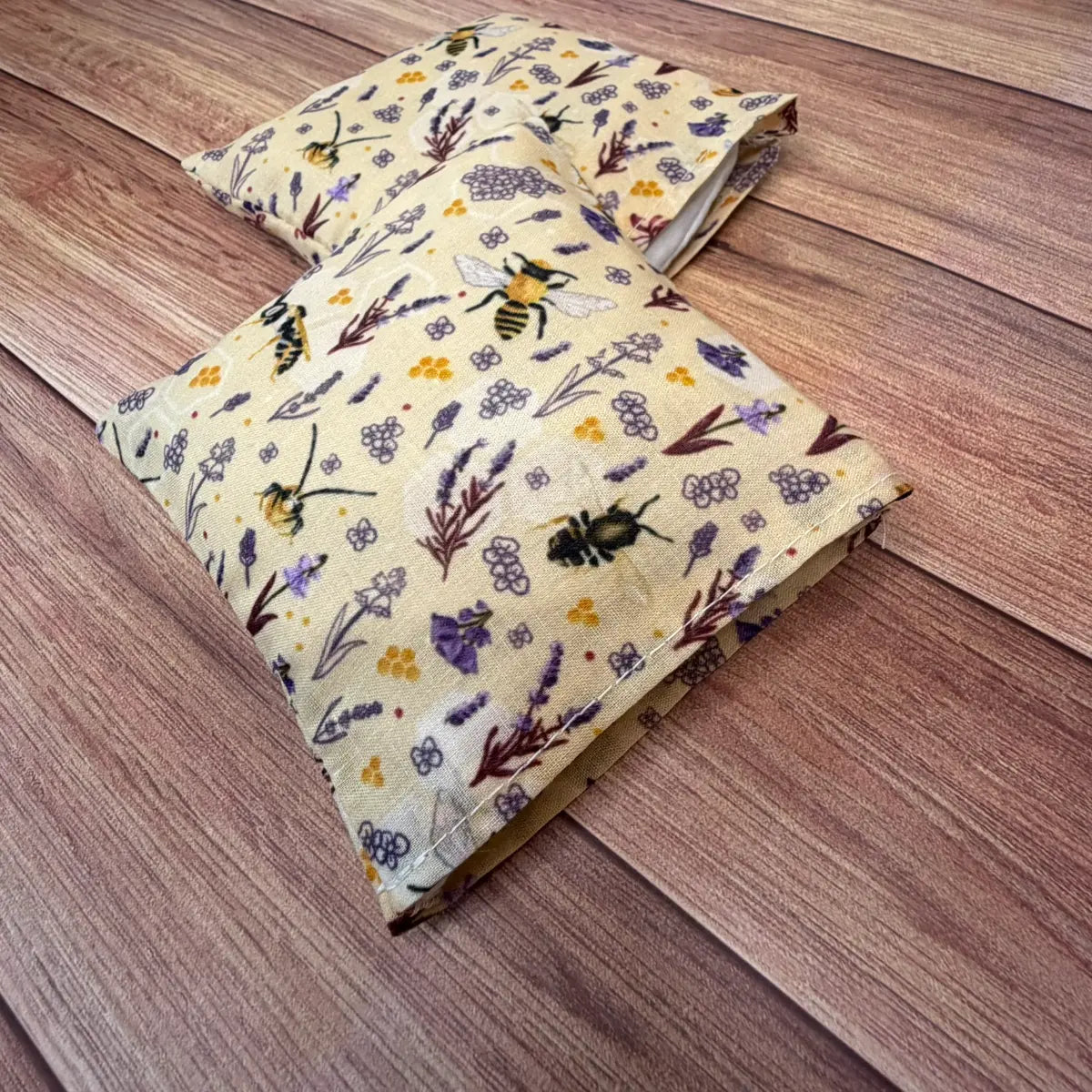 Reusable fabric hand warmers decorated with an original repeating bee design.
