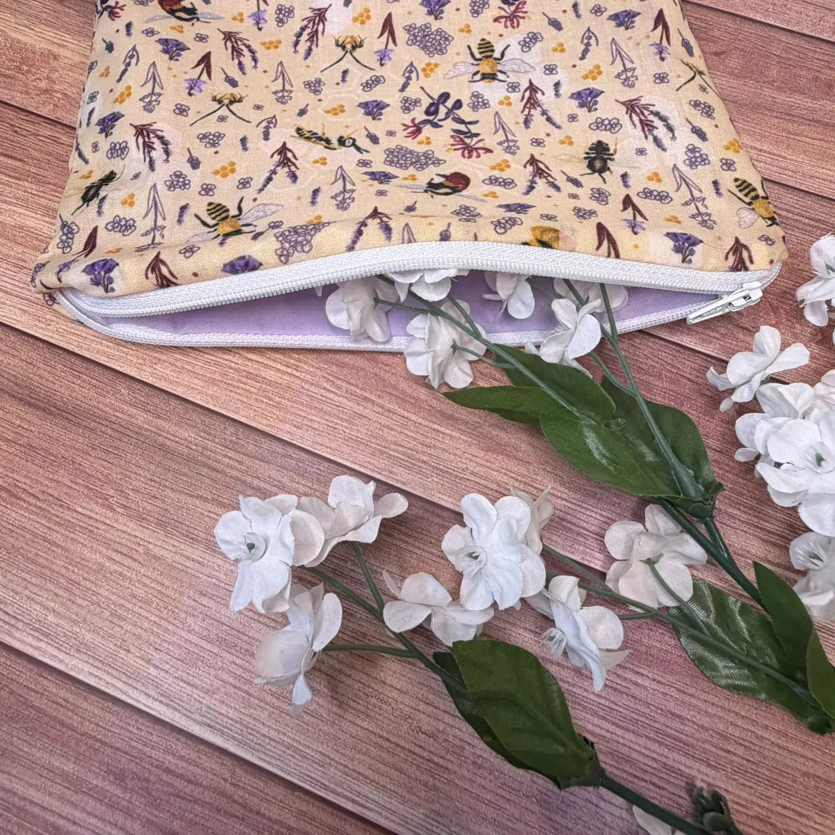 Bee cosmetic pouch made from soft avio cotton with a contrasting purple polycotton lining.

