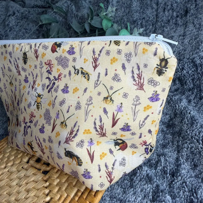 Handmade bee patterned travel wash bag with waterproof lining, suitable for weekends away and holidays.
