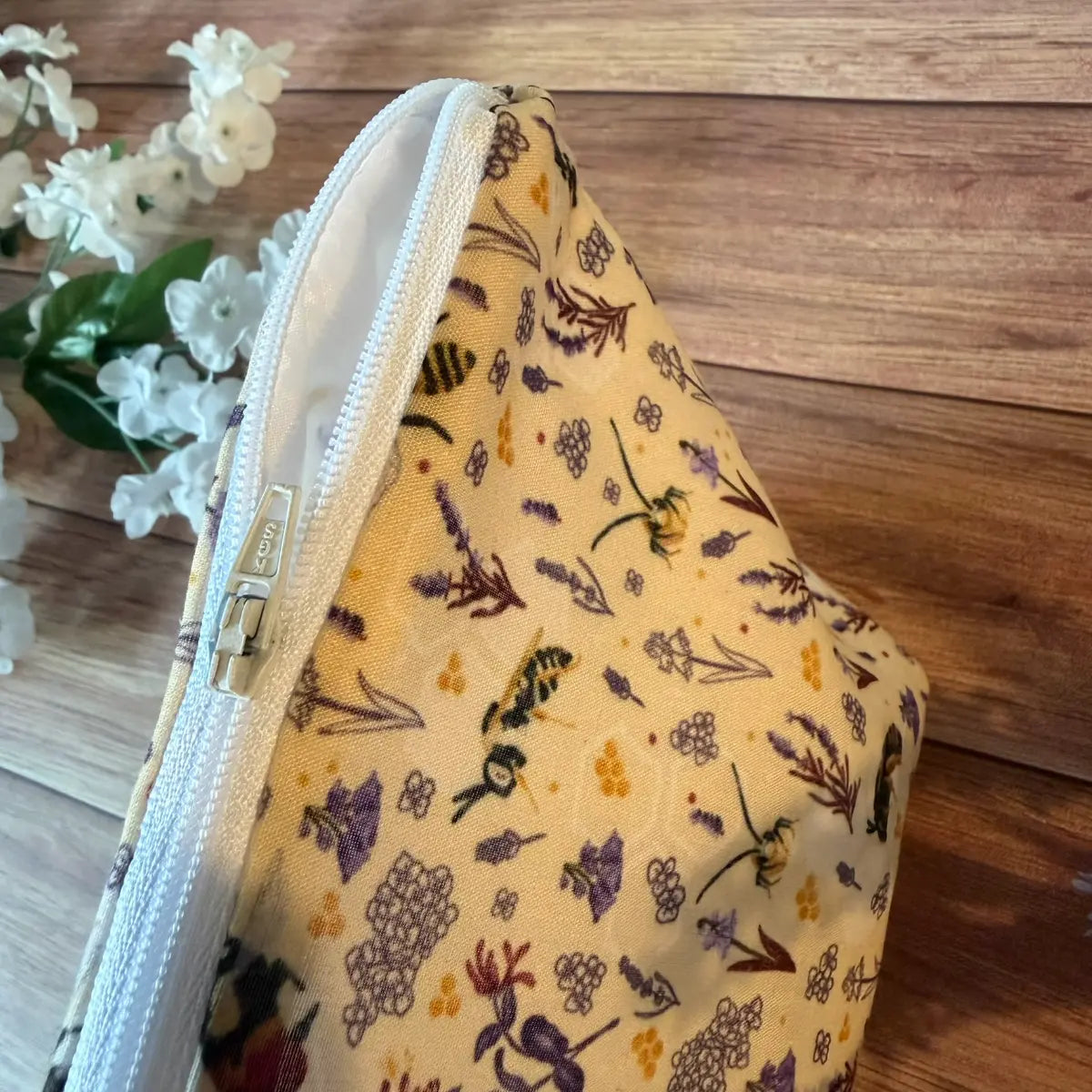Bee wash bag made from soft printed avio cotton with a white waterproof nylon lining.
