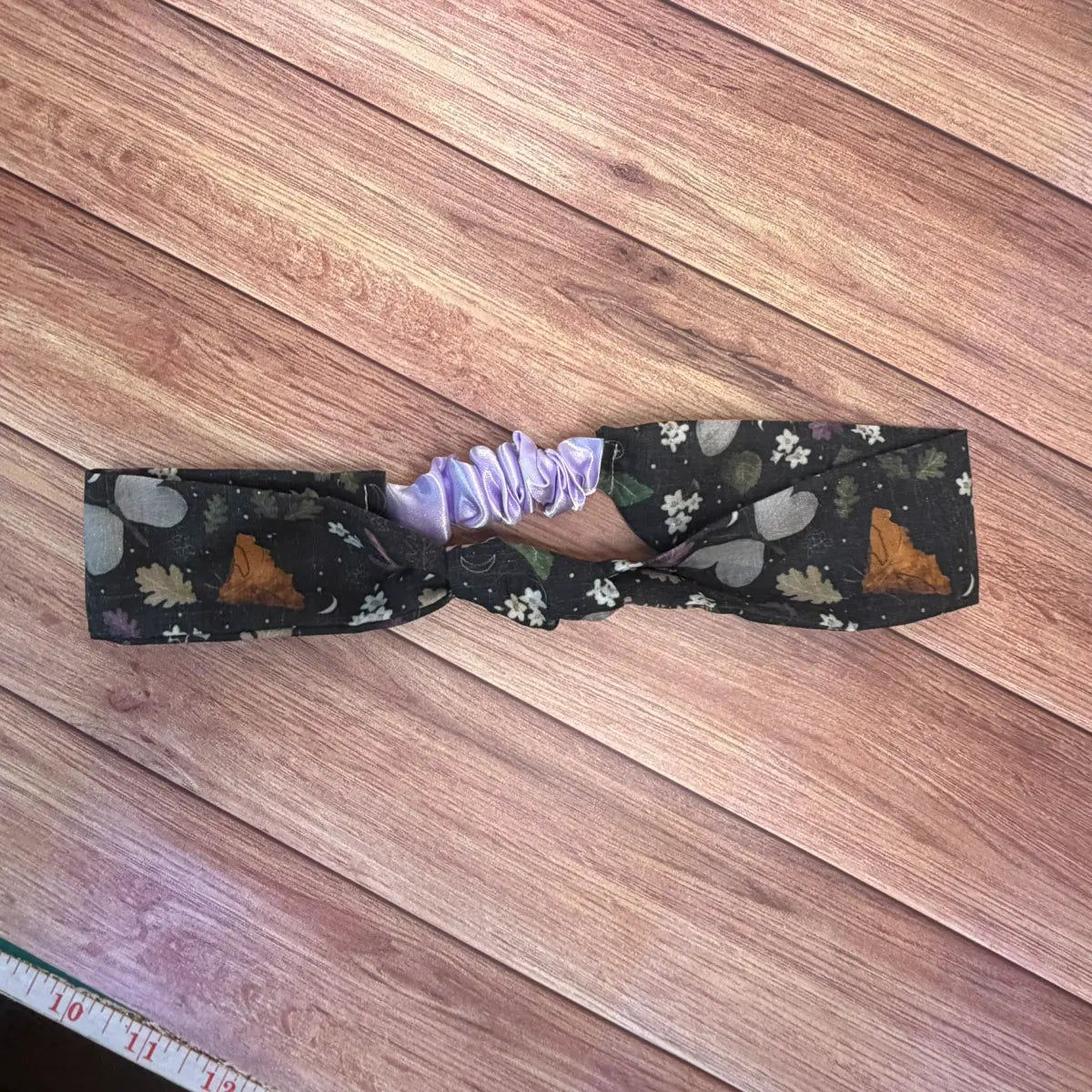 Black hairband with original illustrated insect artwork.
