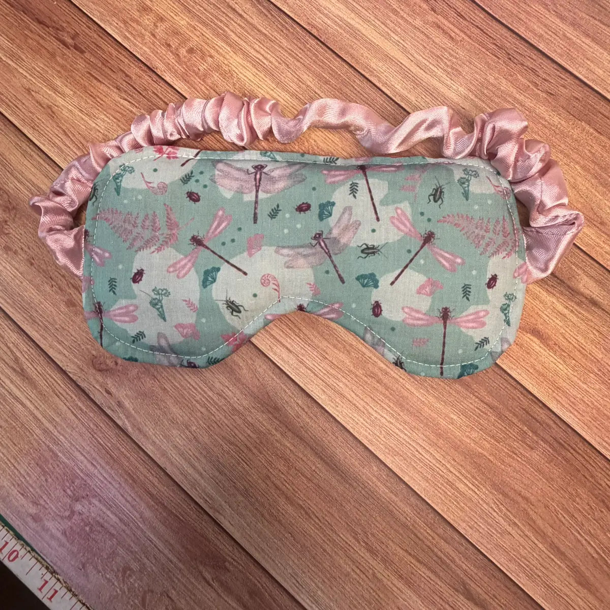 Dragonfly eye mask with an elasticated fabric-covered strap for bedtime or travel.
