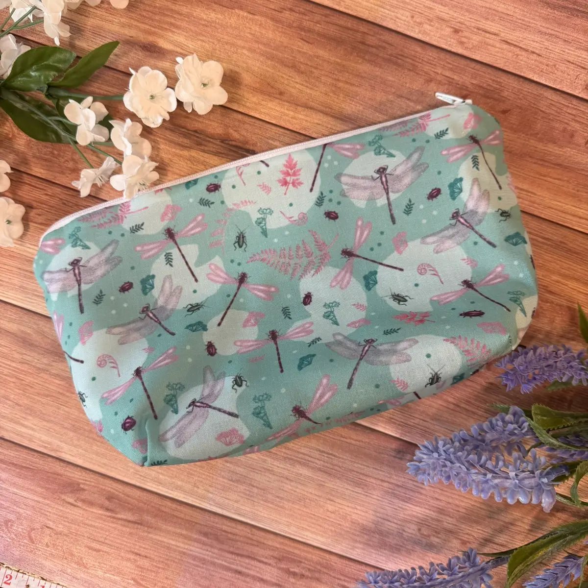 Fabric wash bag featuring a repeating dragonfly pattern inspired by nature.
