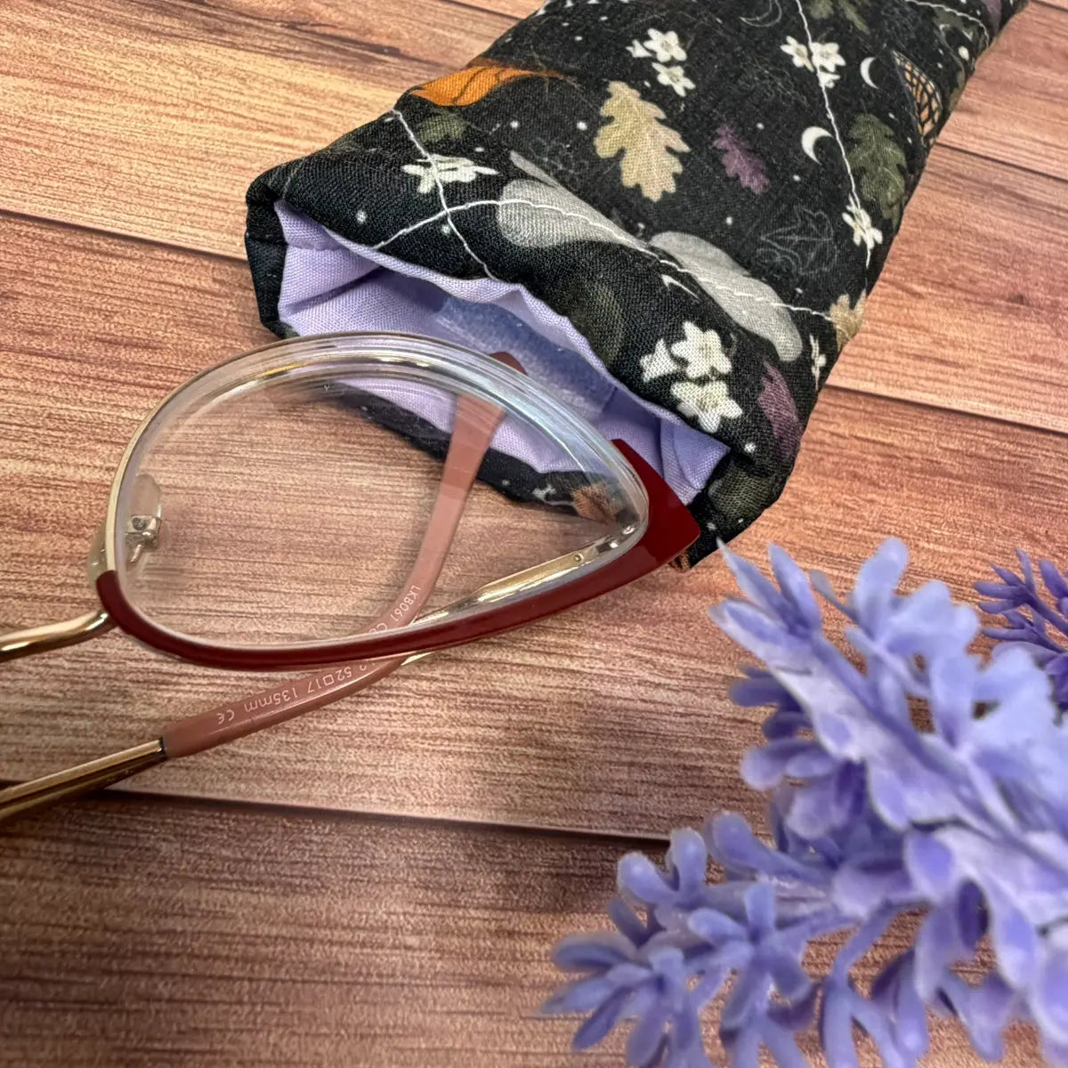 Fabric sunglasses case for women featuring an original illustrated moth design.
