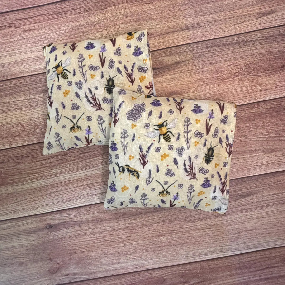 Bee patterned hottie wheat bag style hand warmers filled with wheat and lavender.
