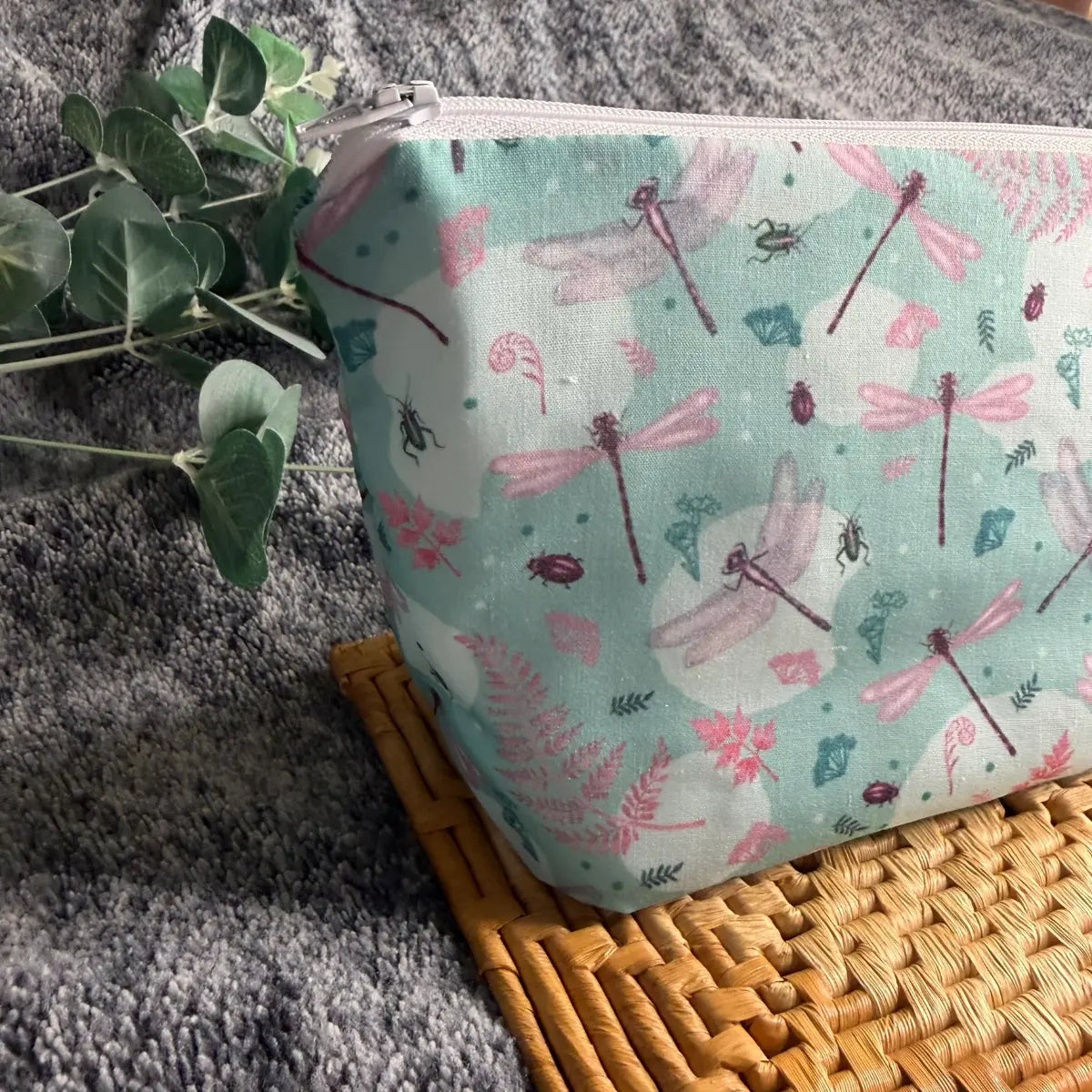 Dragonfly toiletry bag made from soft printed avio cotton with a white waterproof nylon lining.
