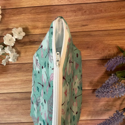 Large wash bag decorated with dragonfly artwork, suitable for toiletries and makeup brushes.
