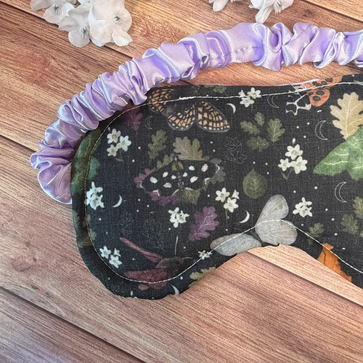 Handmade moth eye cover featuring a fabric-covered elasticated strap.
