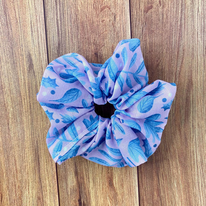 blue and pink foliage surface pattern design on a scrunchie, on a wooden background
