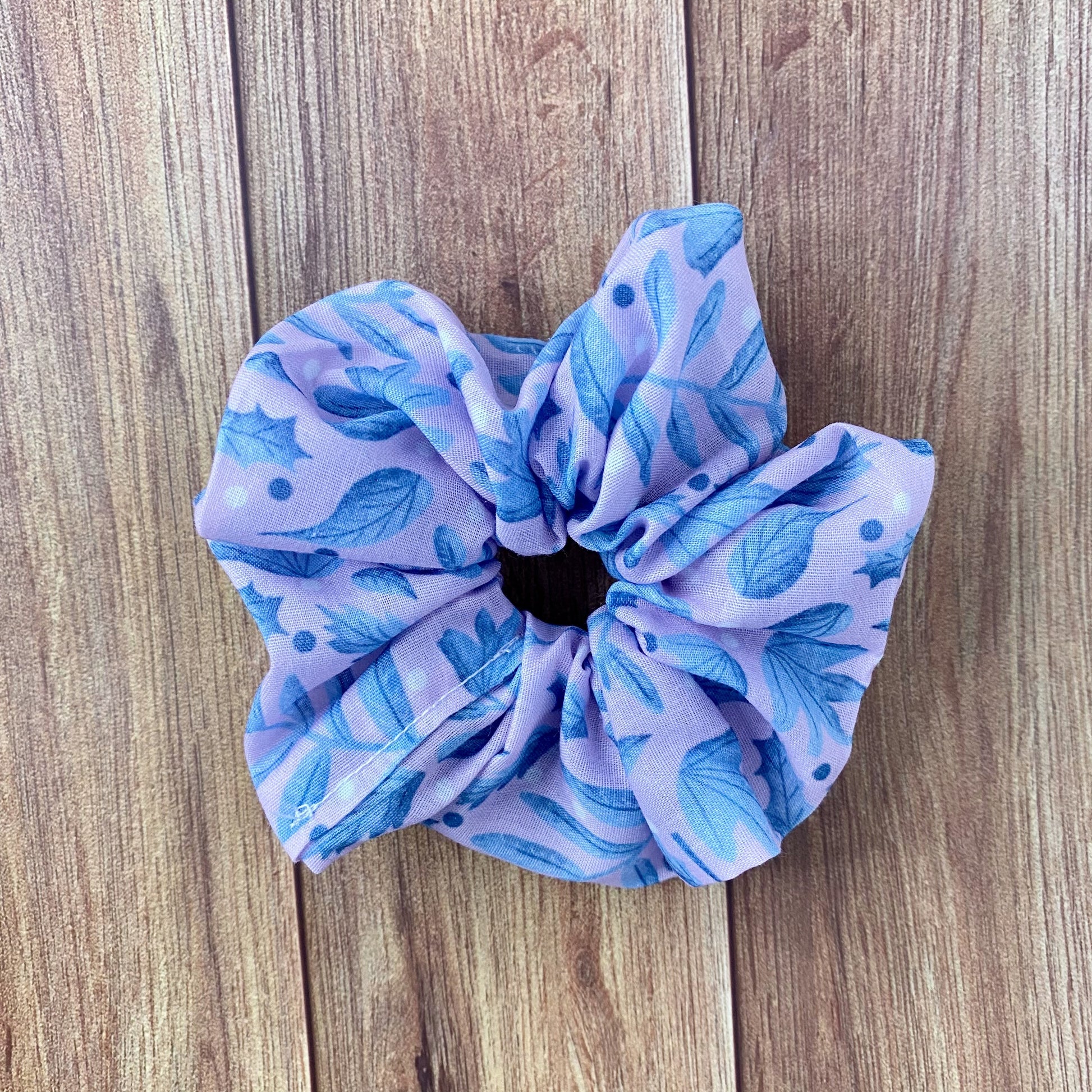 blue foliage scrunchie on wooden background