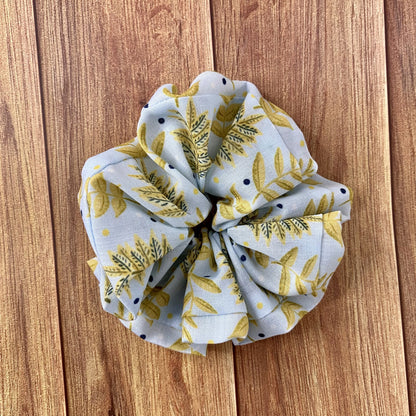 yellow foliage scrunchie on wood surface