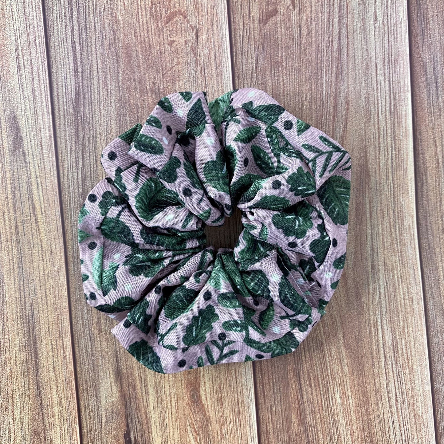 green scrunchie on wooden background