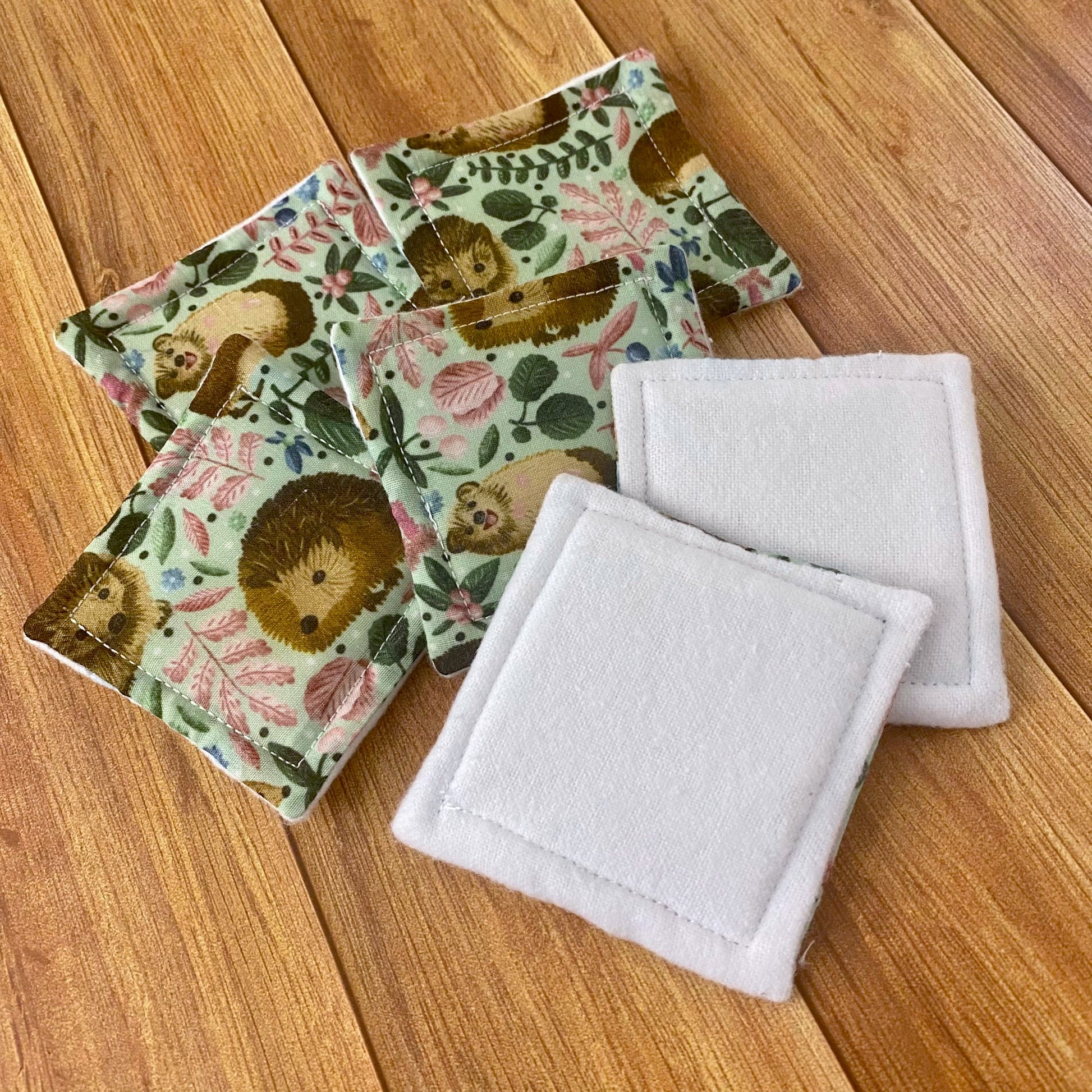 photograph of six reusable skincare pads, with two flipped to show the white brushed cotton side.