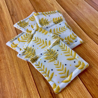 yellow foliage patterned reusable skincare pads on a wooden background