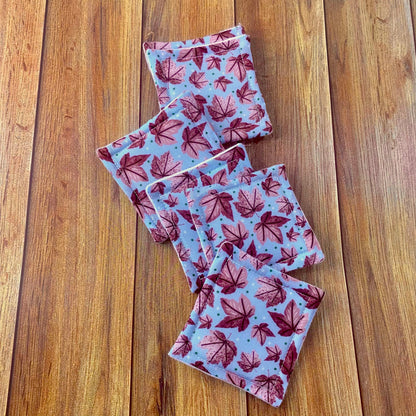 pink leafy patterned reusable makeup removal pads on wood surface