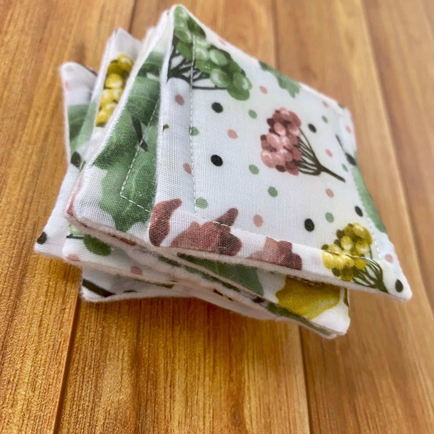 Closeup of a stack of reusable skinmcare pads with a pretty foliage surface pattern design on it