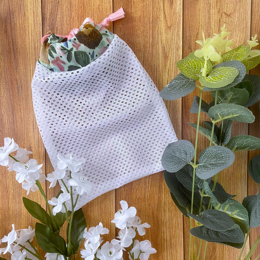 hedgehog patterned washbag on a wooden background with foliage around it