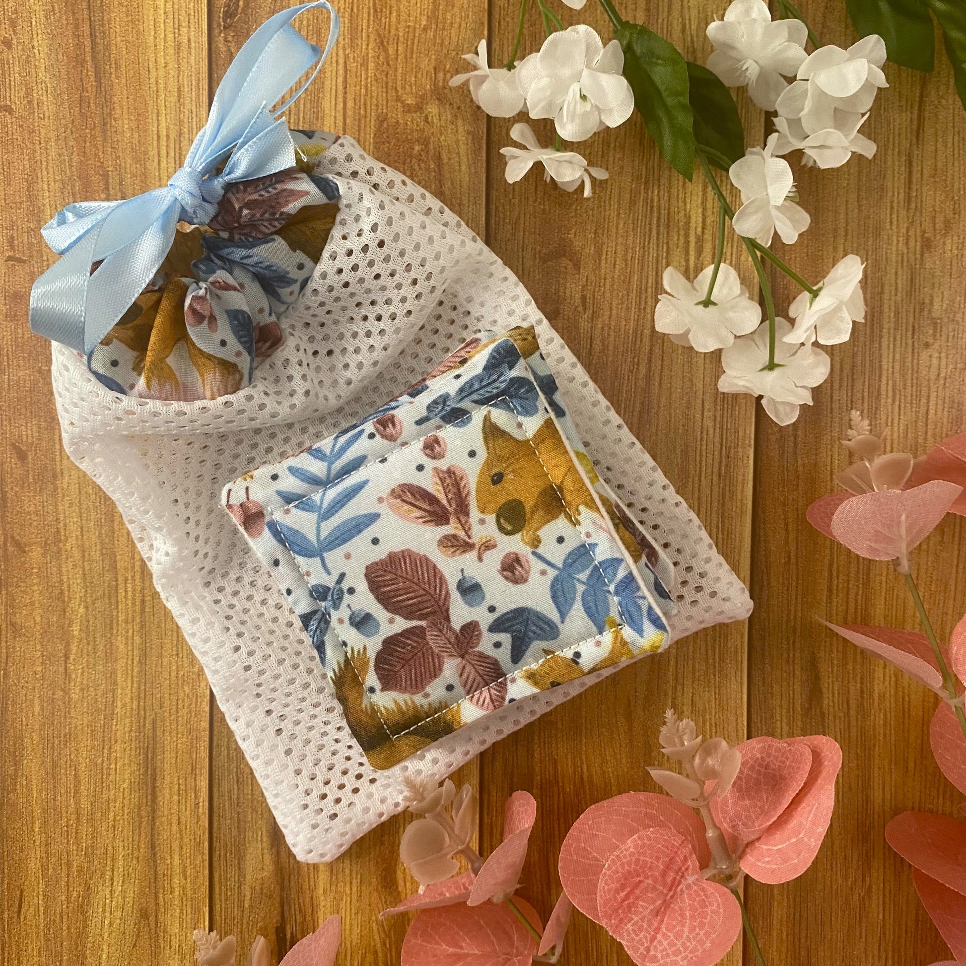 red squirrel patterned skincare pads and washbag on wooden background
